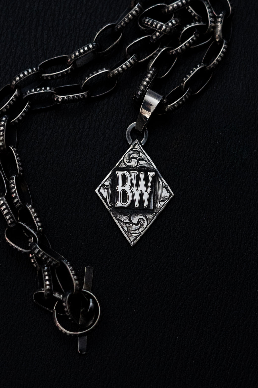 Diamond pendant with initials/brand
