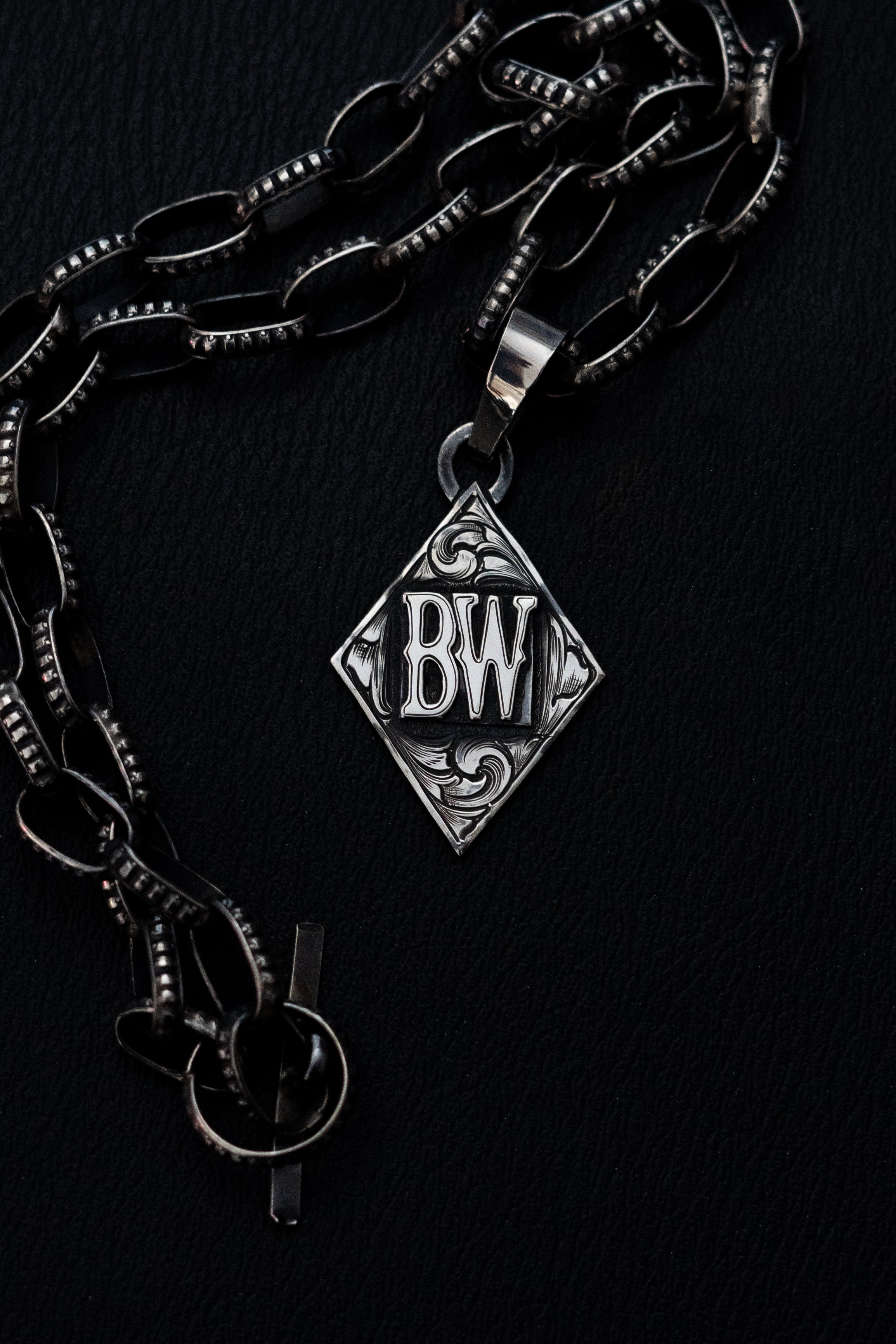 Diamond pendant with initials/brand